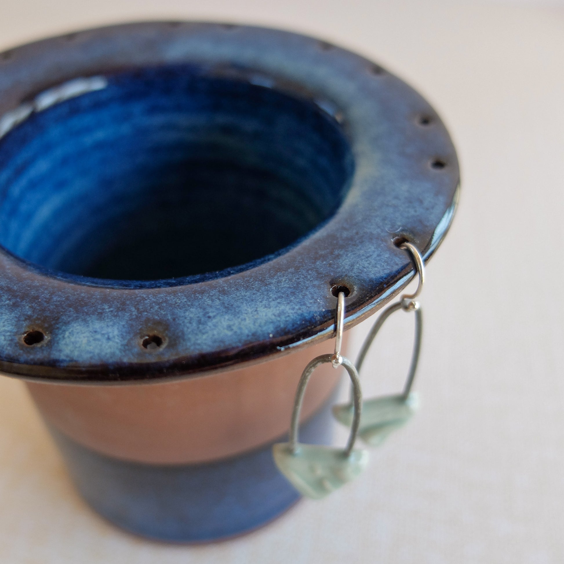 Detail shot of handmade clay earring storage pot